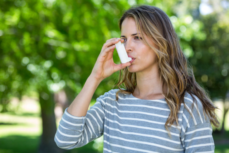 woman using inhaler