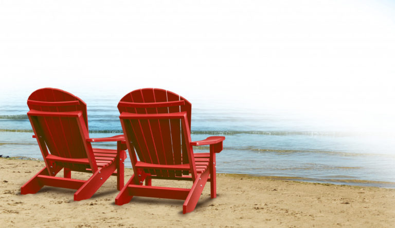 two red airondack chair in front of the beach