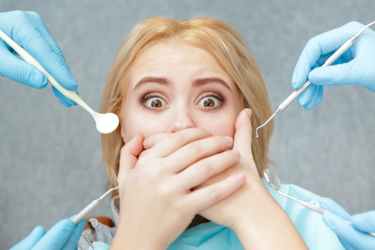 woman feeling scared at the dentist
