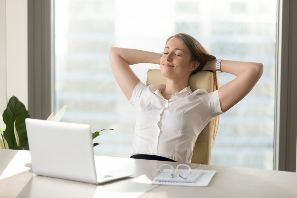 woman resting in her ergonomic chair in her home office