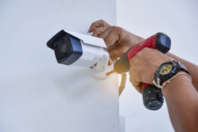 a man installing a security camera