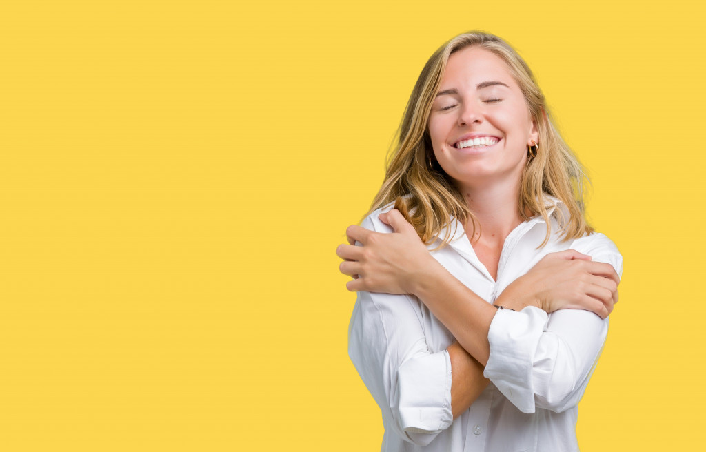 woman hugging herself